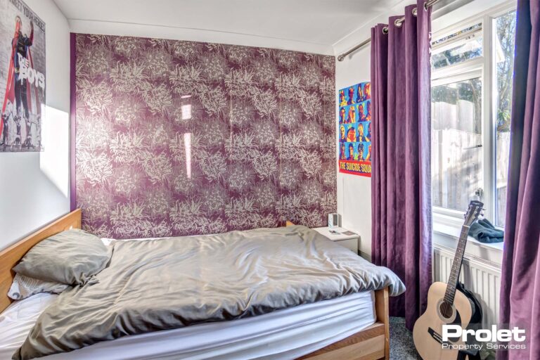 Downstairs double bedroom with purple wallpaper