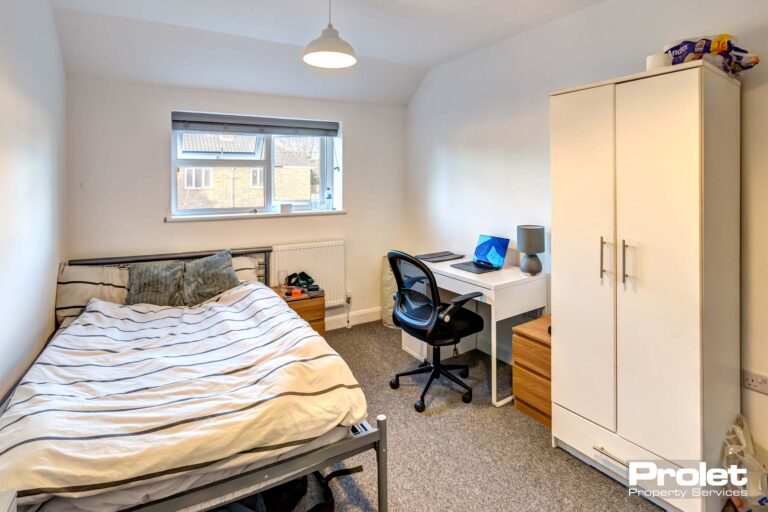 Large double bedroom with desk and white wardrobe