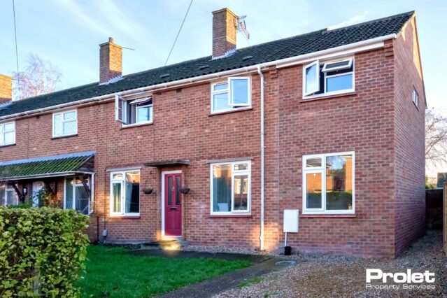 Large semi-detached house with gravel driveway and front lawn.