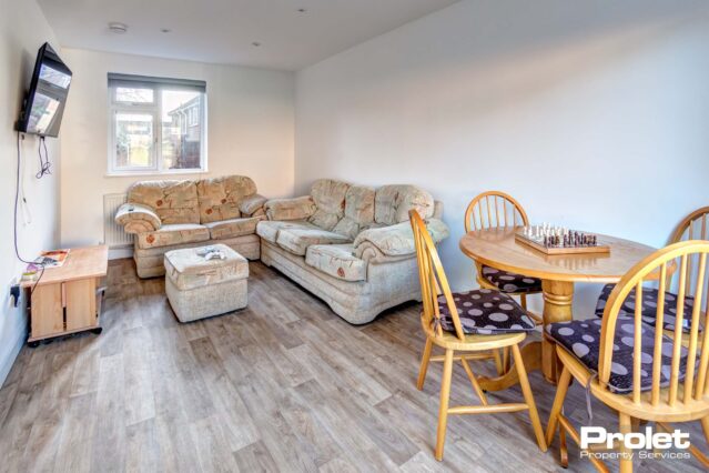 Large living/dining room with sofas, and dining table and chairs.