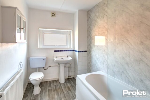 White walls with white suits and shower over bath