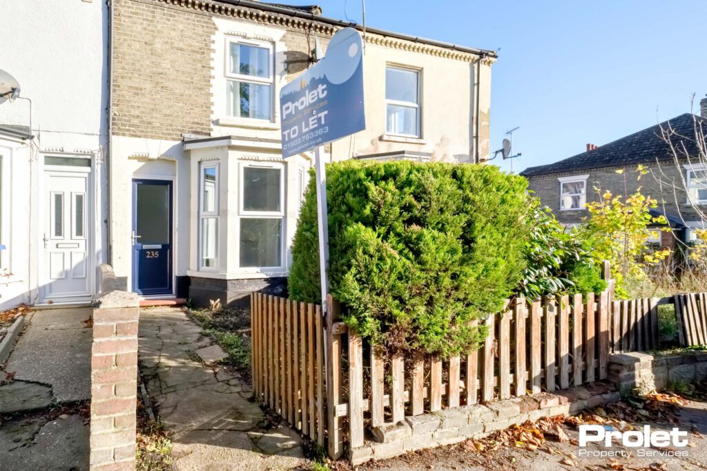 Brick house with bay window. Gated patch to small front garden