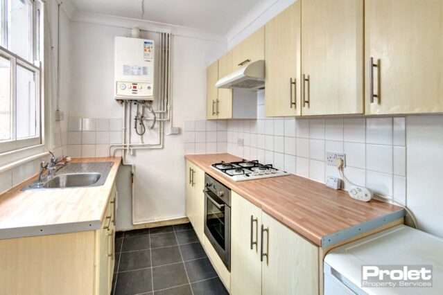 Kitchen with beech effect worktops, gas hob, new oven and washing machine