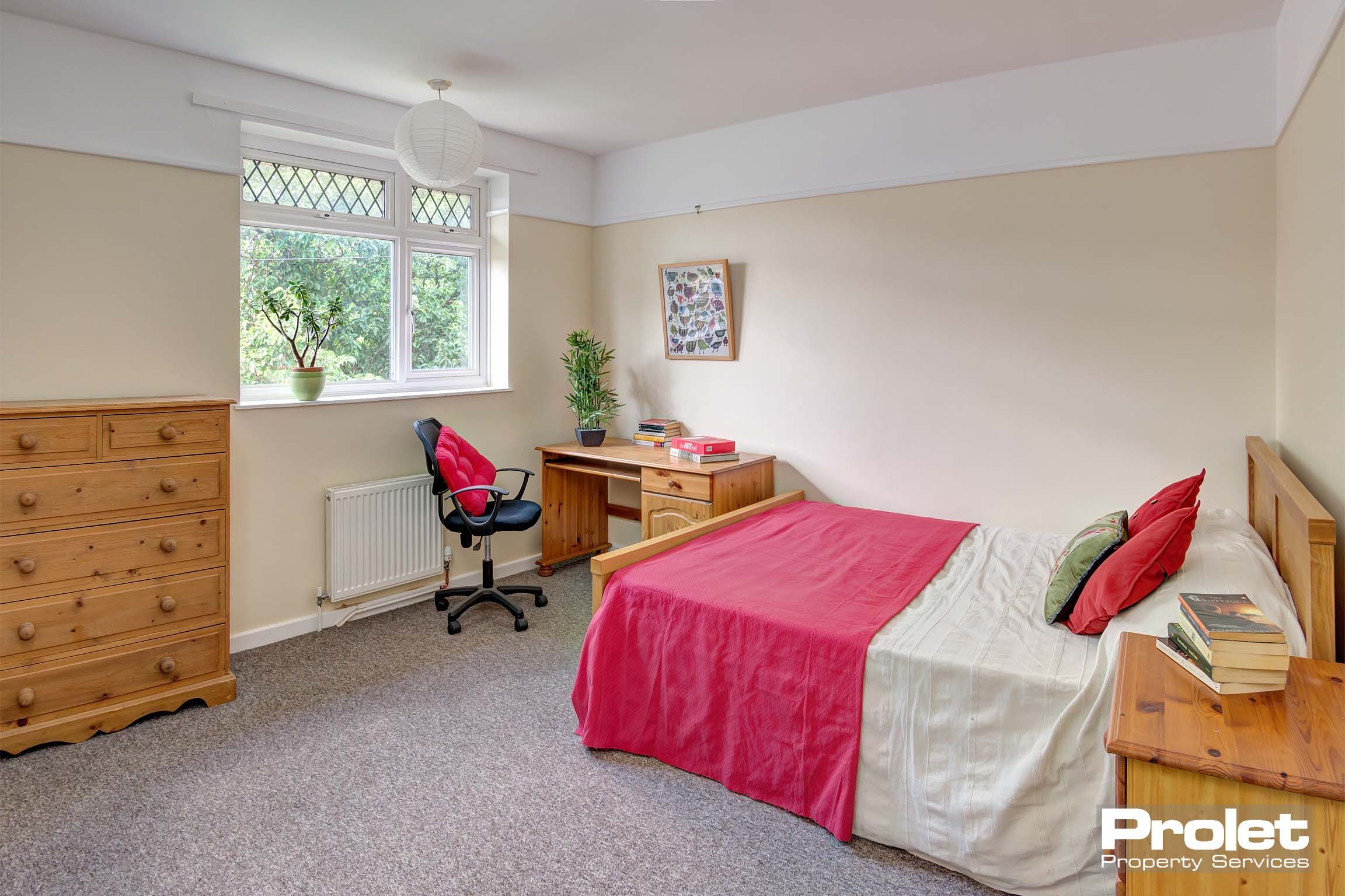 Large double bedroom with desk and bed