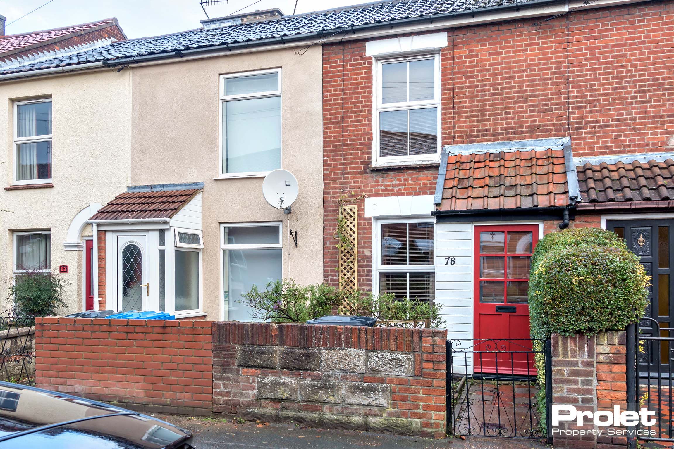Red brick terrace with gate and small front garden. Porch entrance