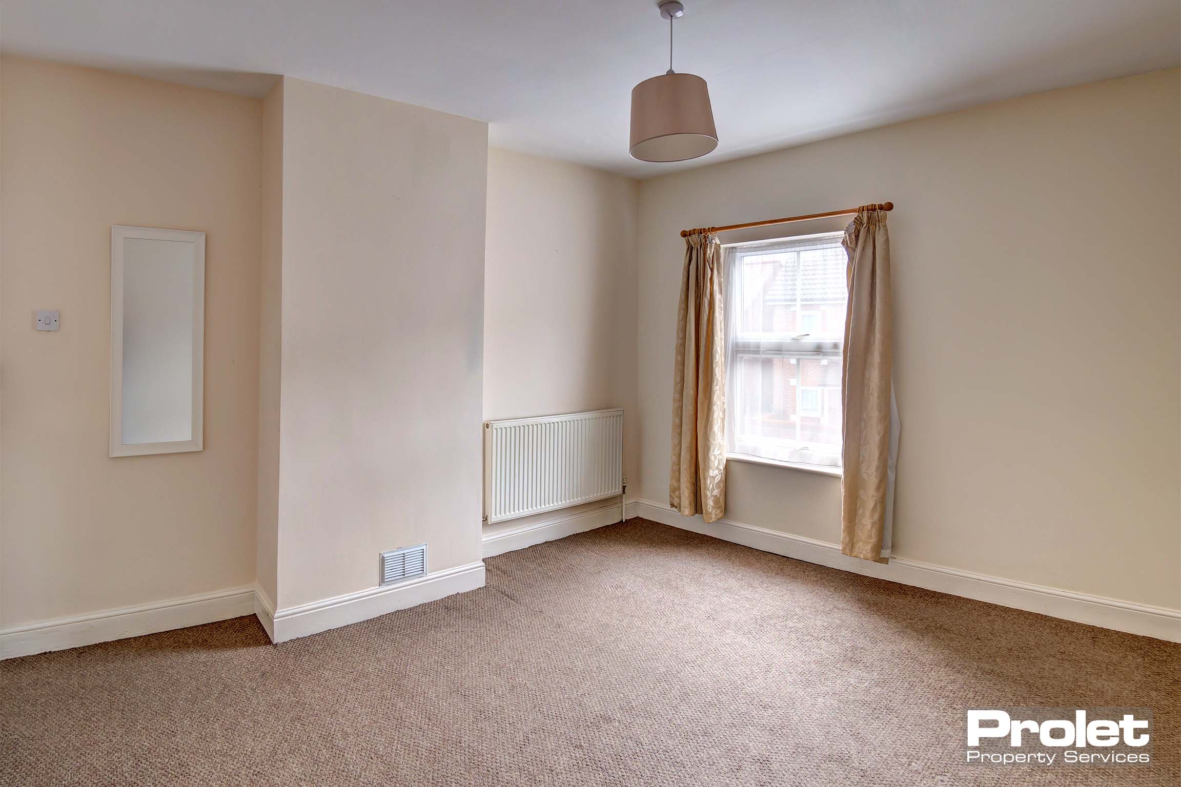 Magnolia walls and brown carpets with neutral shade and curtains