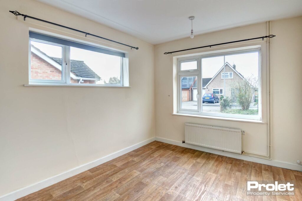 Seperate dining room/study with magnolia walls and laminate flooring