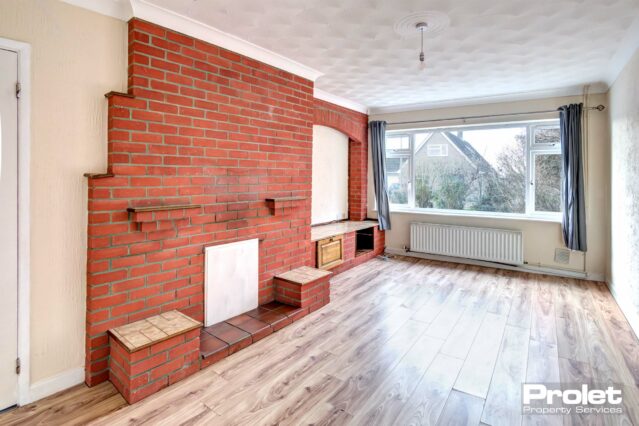 Laminate flooring with red brick wall feature and TV display