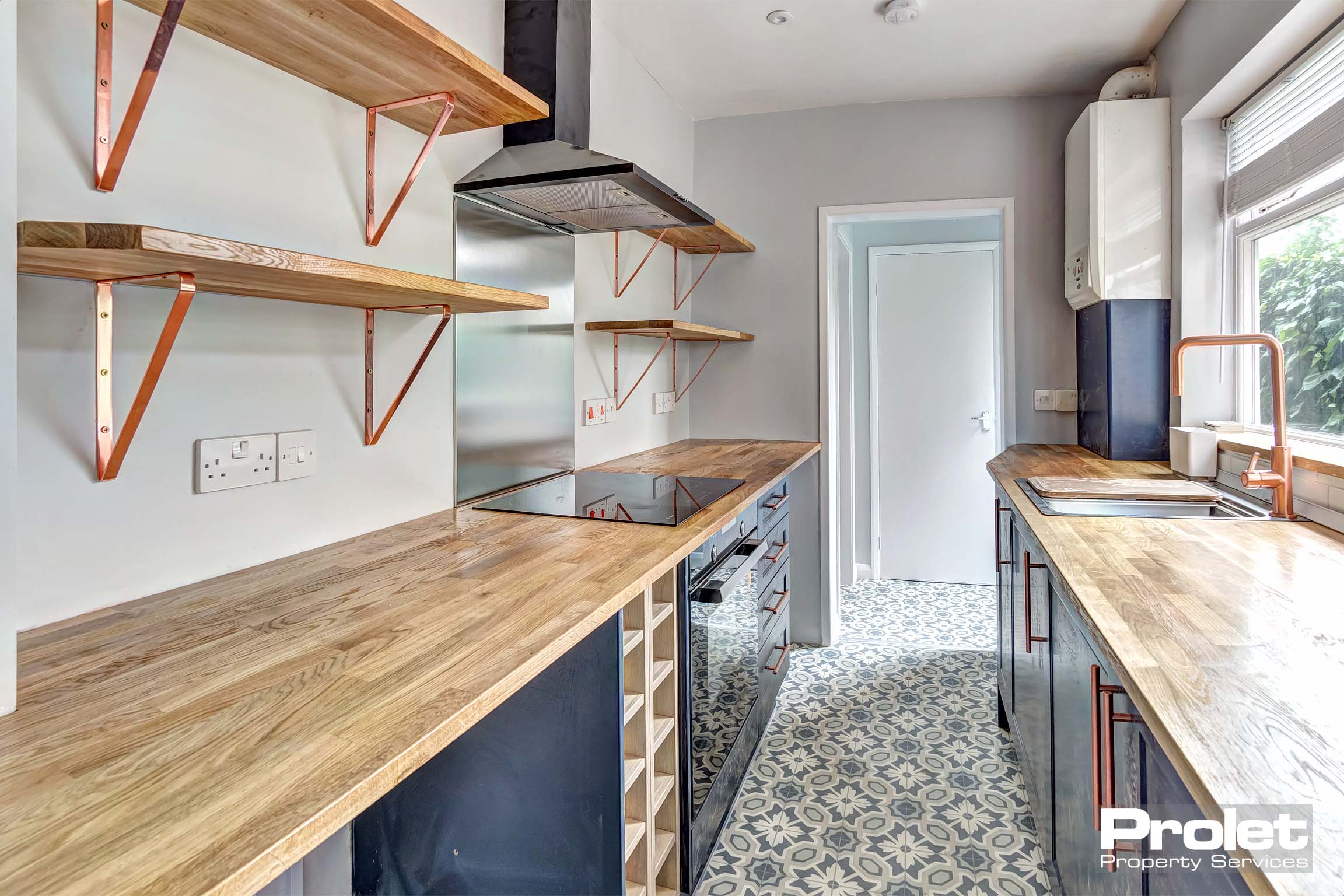 Modern kitchen with wooden worktops and gre units