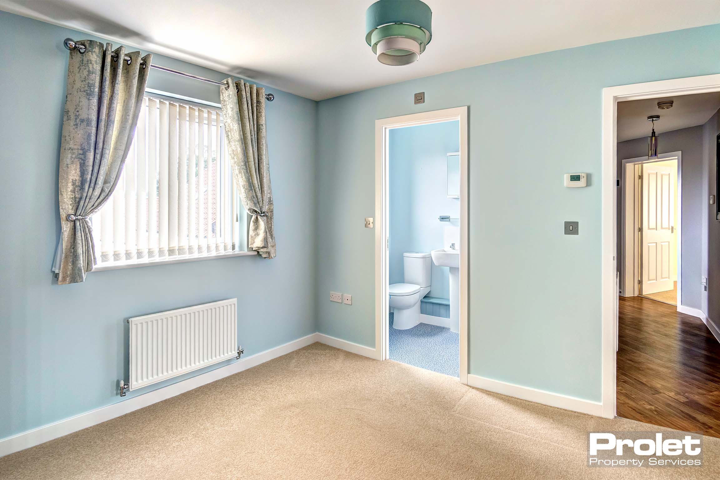 Bedroom with duck egg walls leading to ensuite