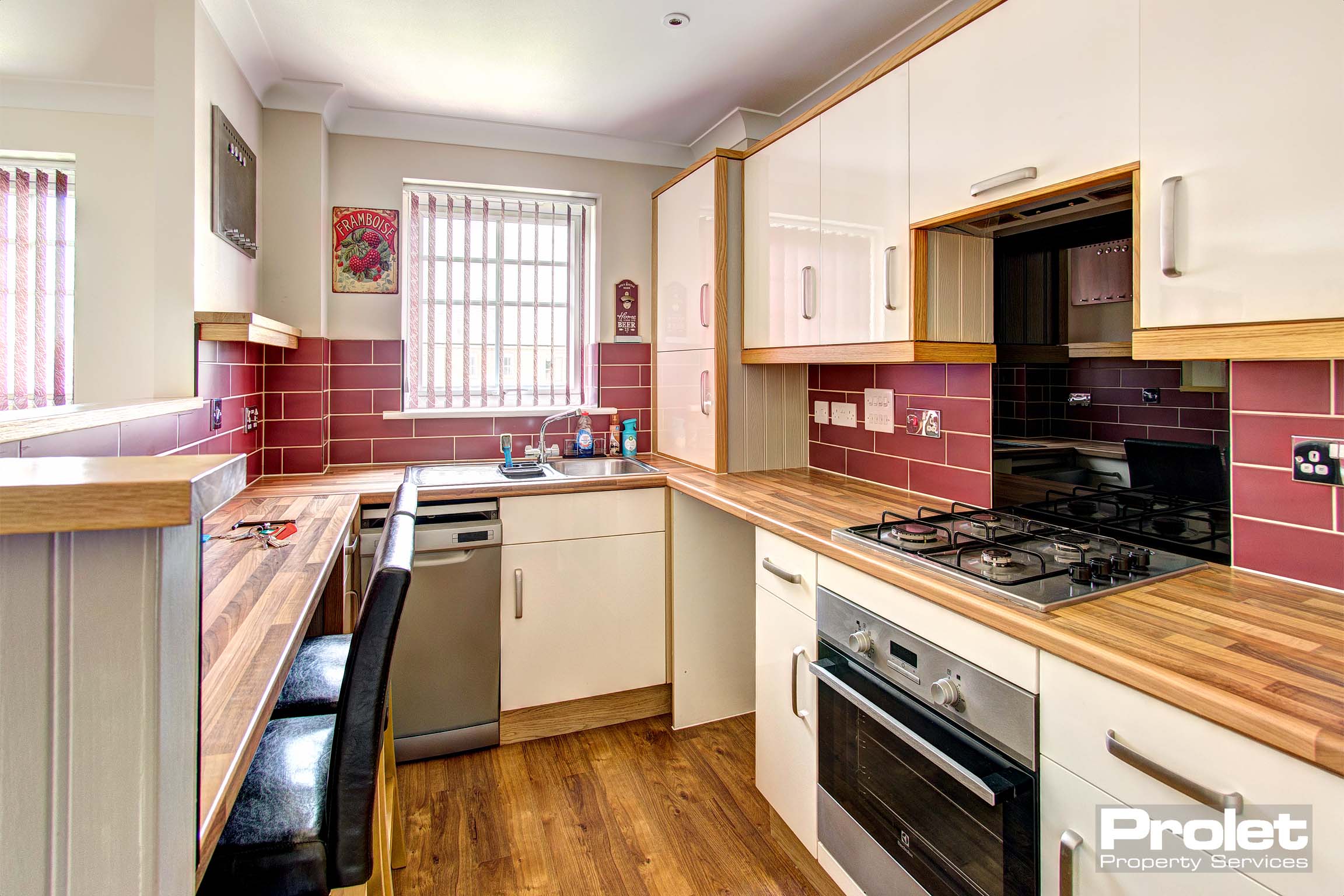 Fitted galley kitchen in lounge with appliances