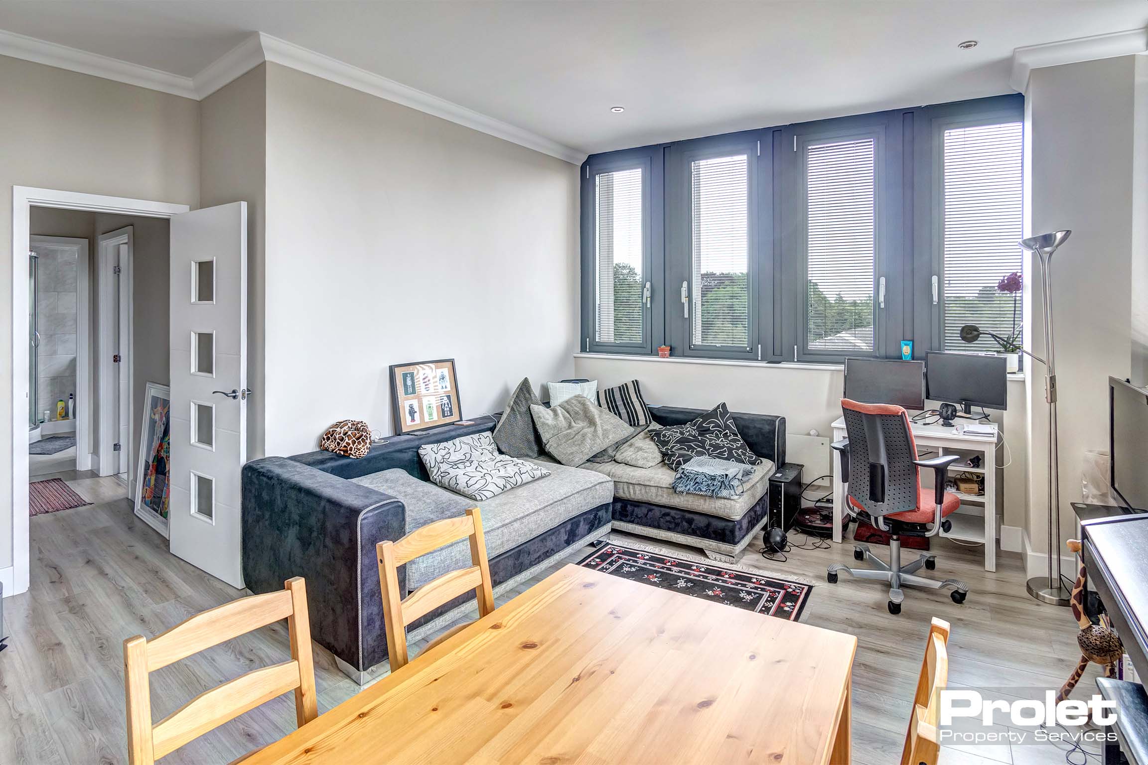 Living/kitchen and dining area with dining set and grey corner sofa