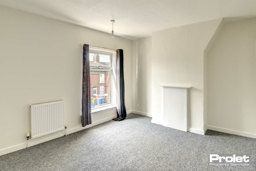 Upstairs double bedroom with white walls, and grey carpet.