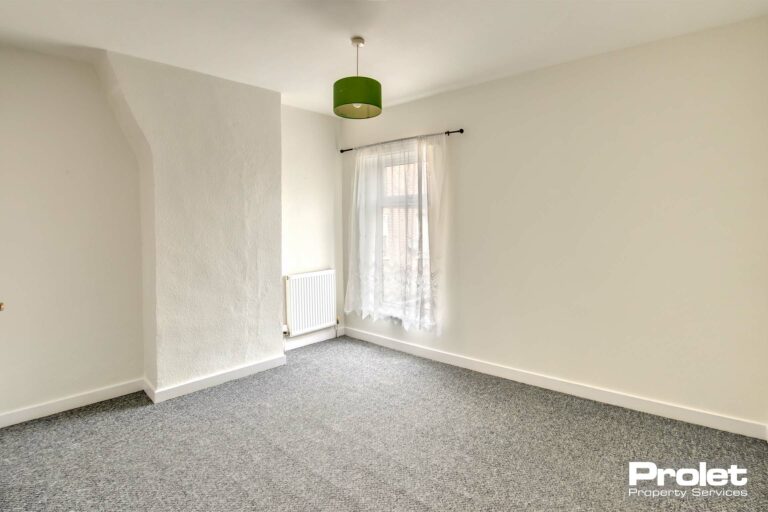 Upstairs double bedroom with white walls, and grey carpet.