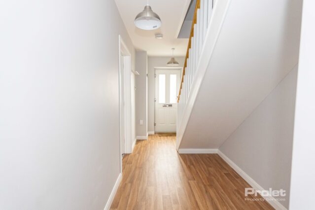 Bright entrance hall with wood effect flooring.
