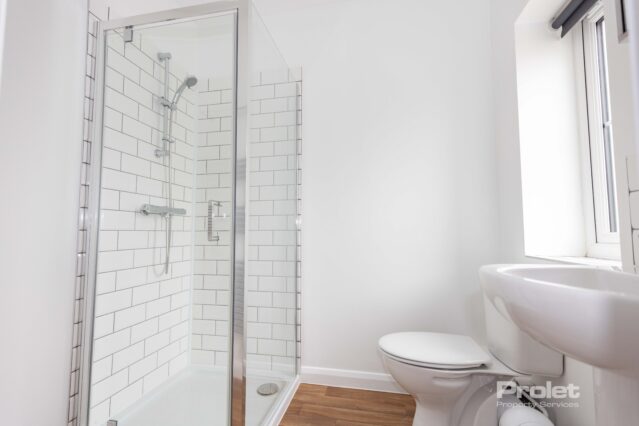 En-suite bathroom with shower cubicle, toilet, and sink