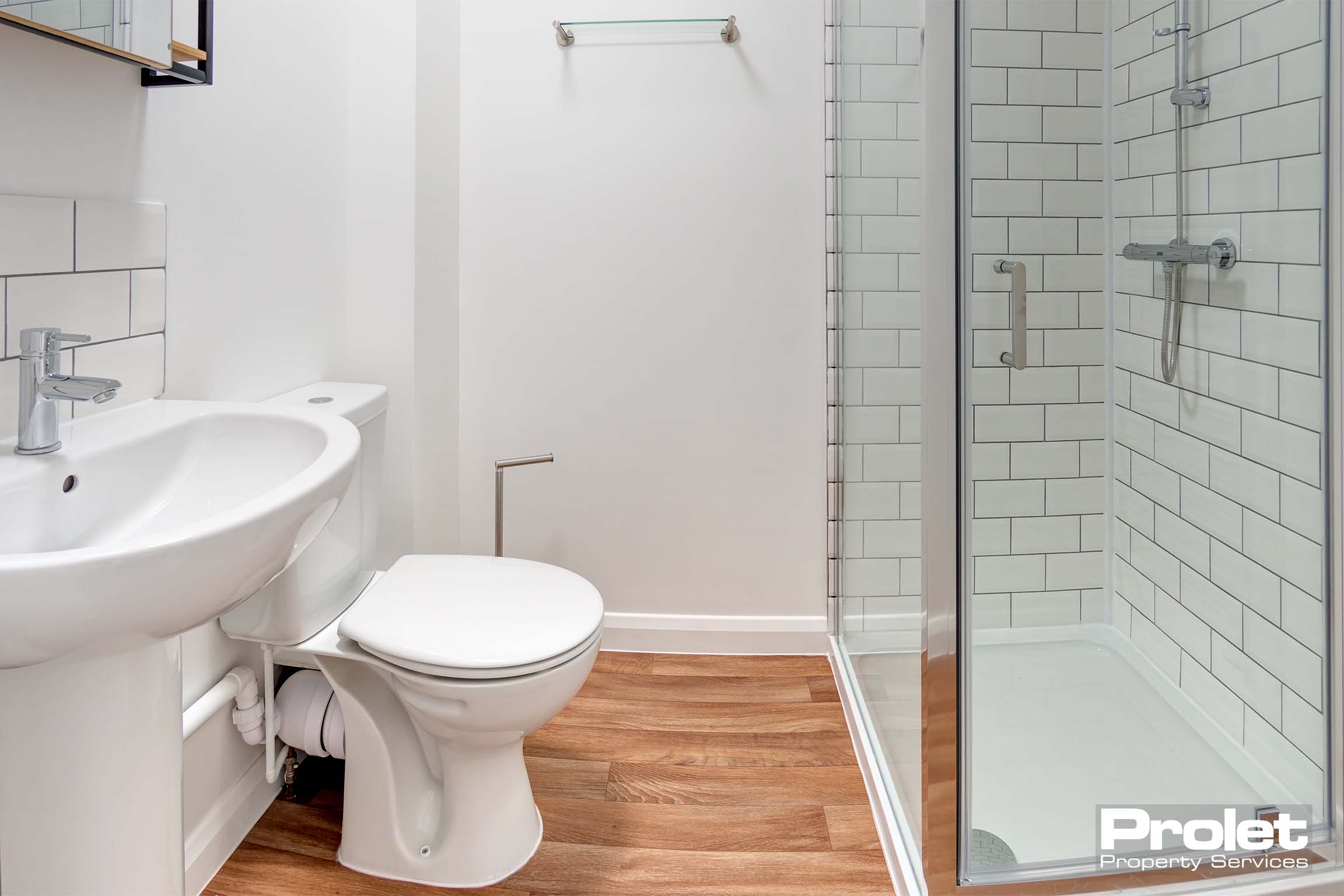 En-suite bathroom with shower cubicle, toilet, and sink