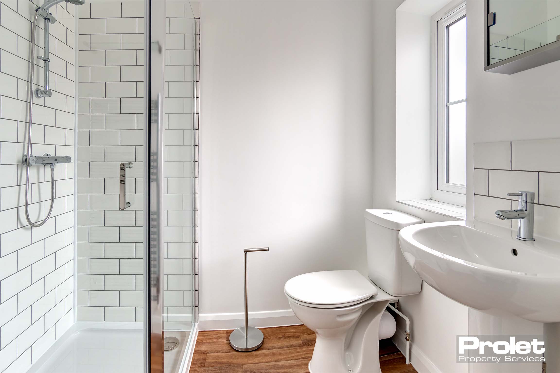 En-suite bathroom with shower cubicle, toilet, and sink