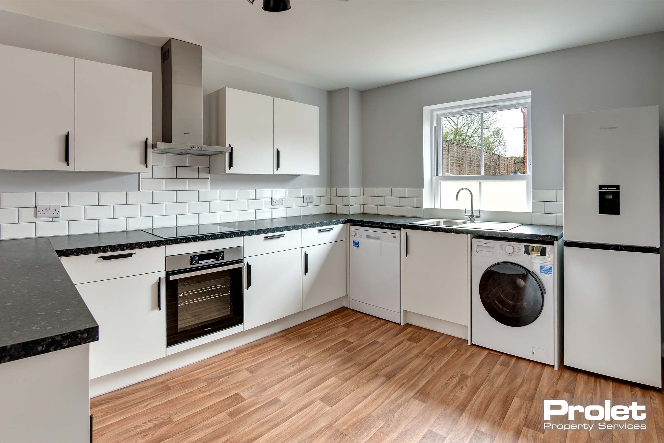 Large kitchen diner with modern cabinets and worktop. Oven, hob, and washing machine