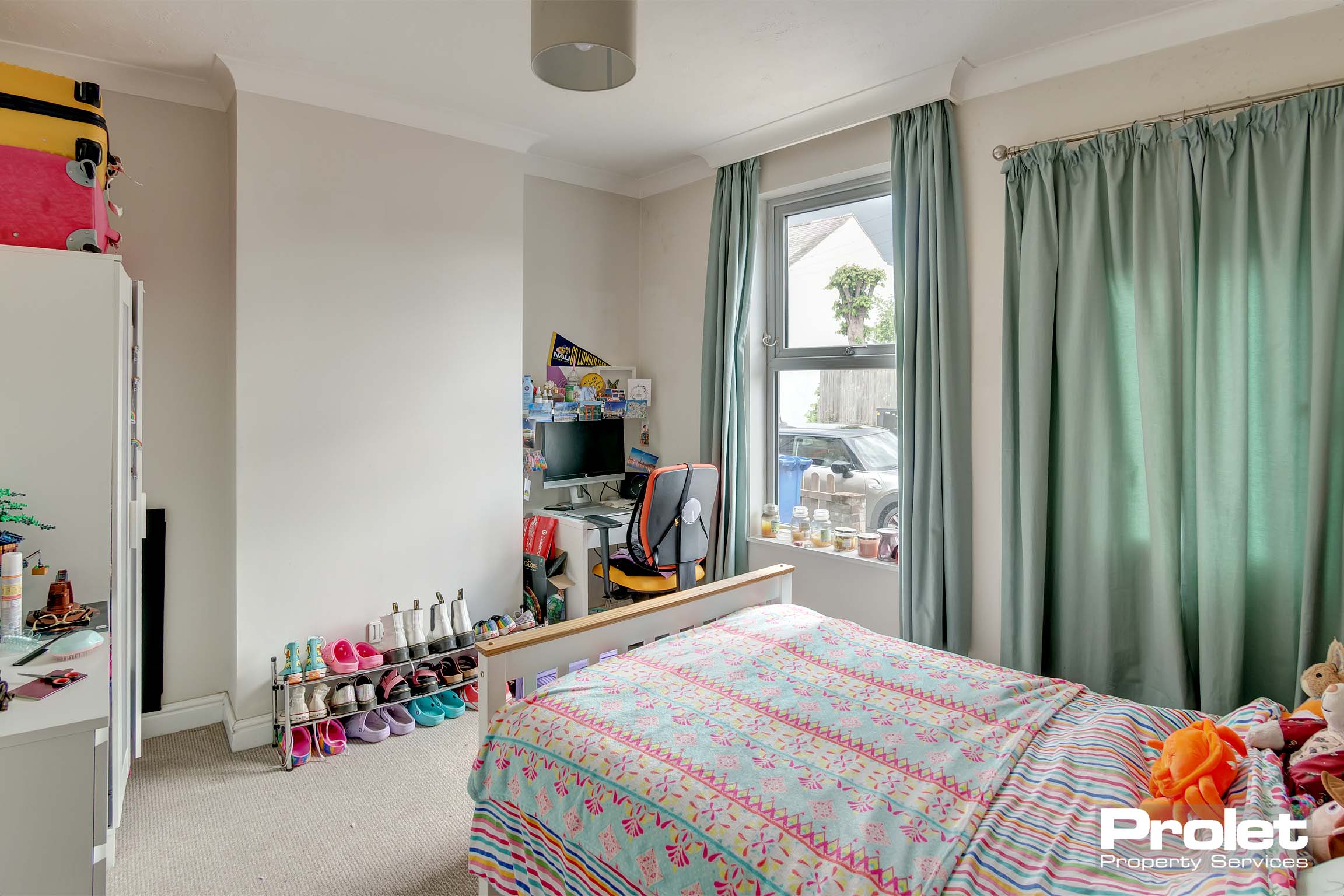 Downstairs bedroom with double bed and desk