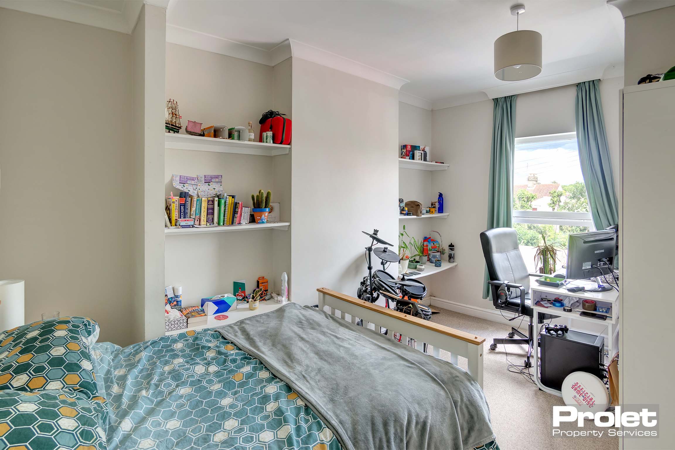 Bedroom with double bed, shelves and desk