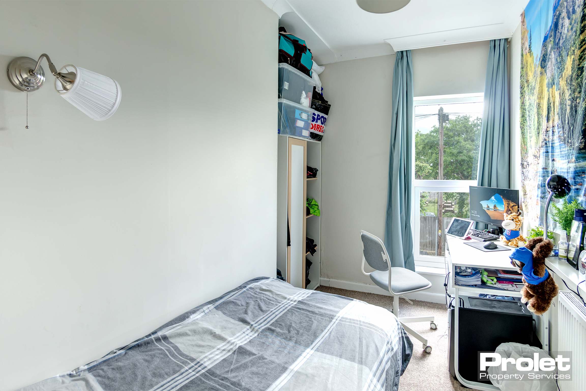 Bedroom with single bed and desk
