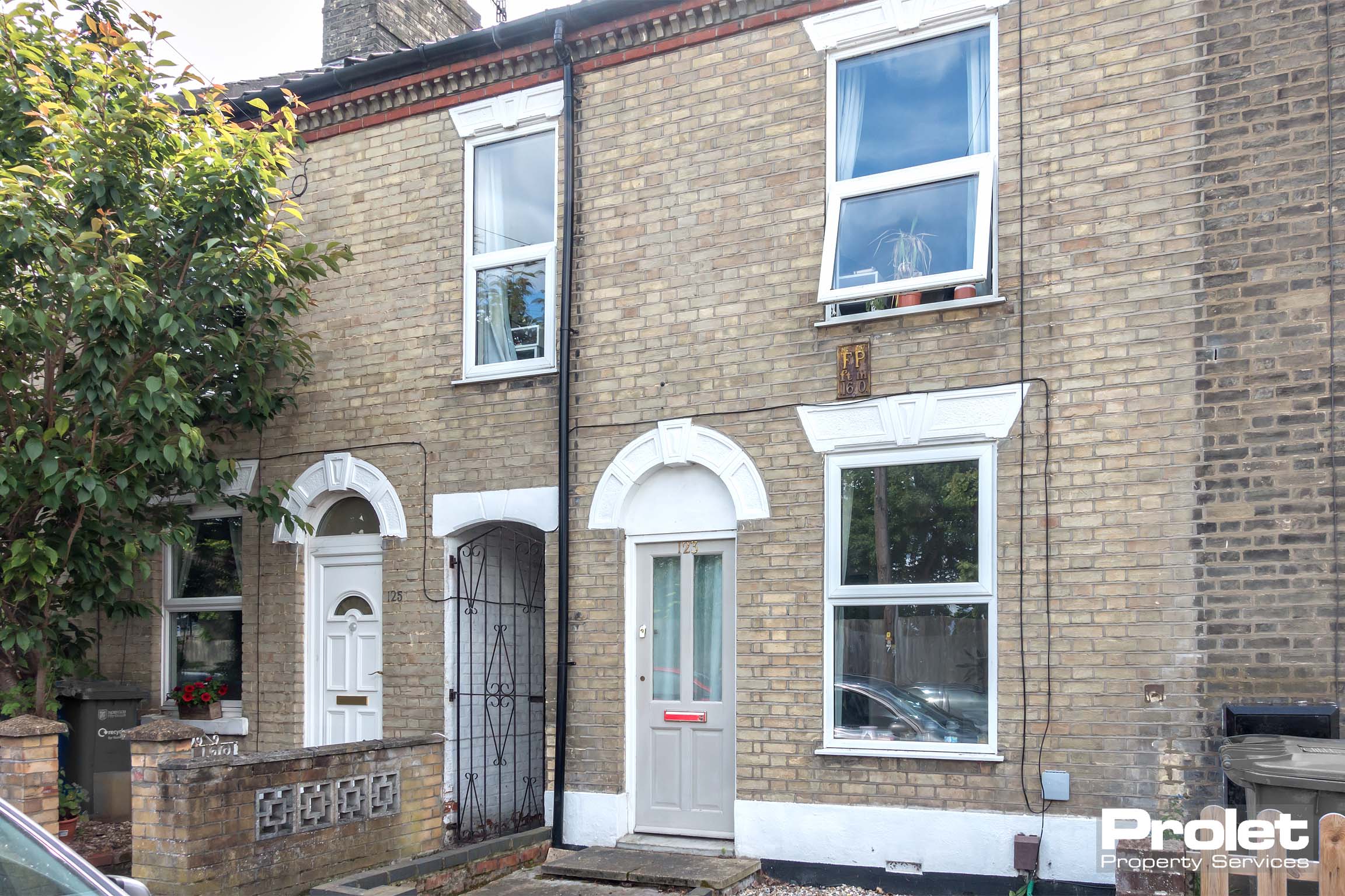 Brick terraced house with grey front door