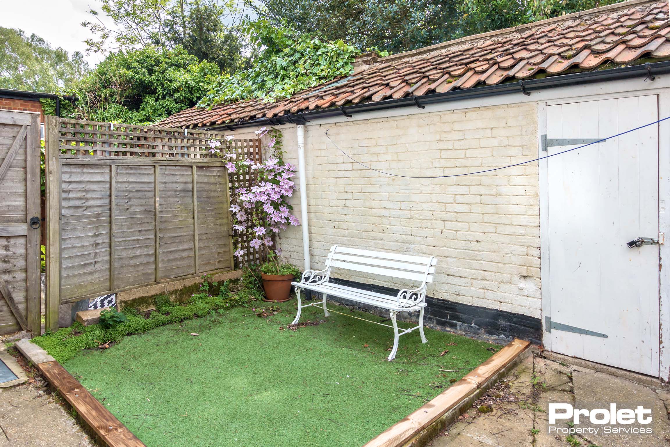 Courtyard style back garden set to lawn