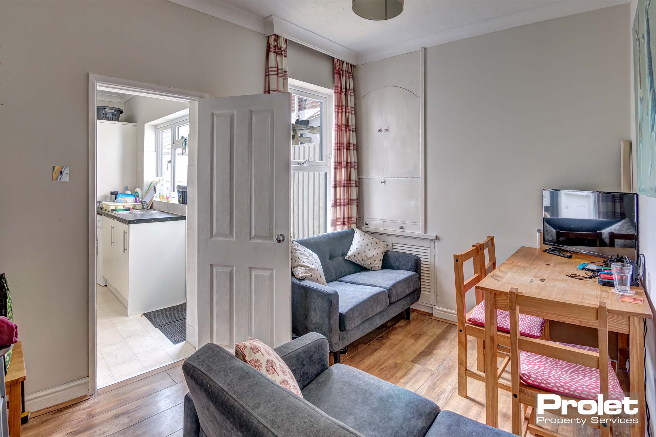 Living/dining area with sofas and dining table set