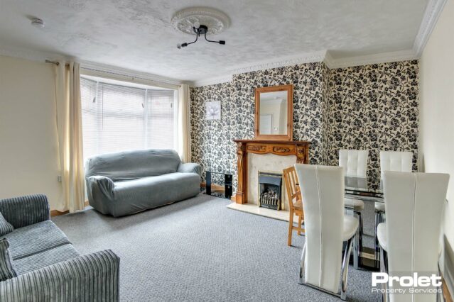 Large living room with sofa and dining table set.