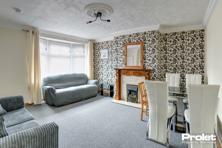 Large living room with sofa and dining table set.