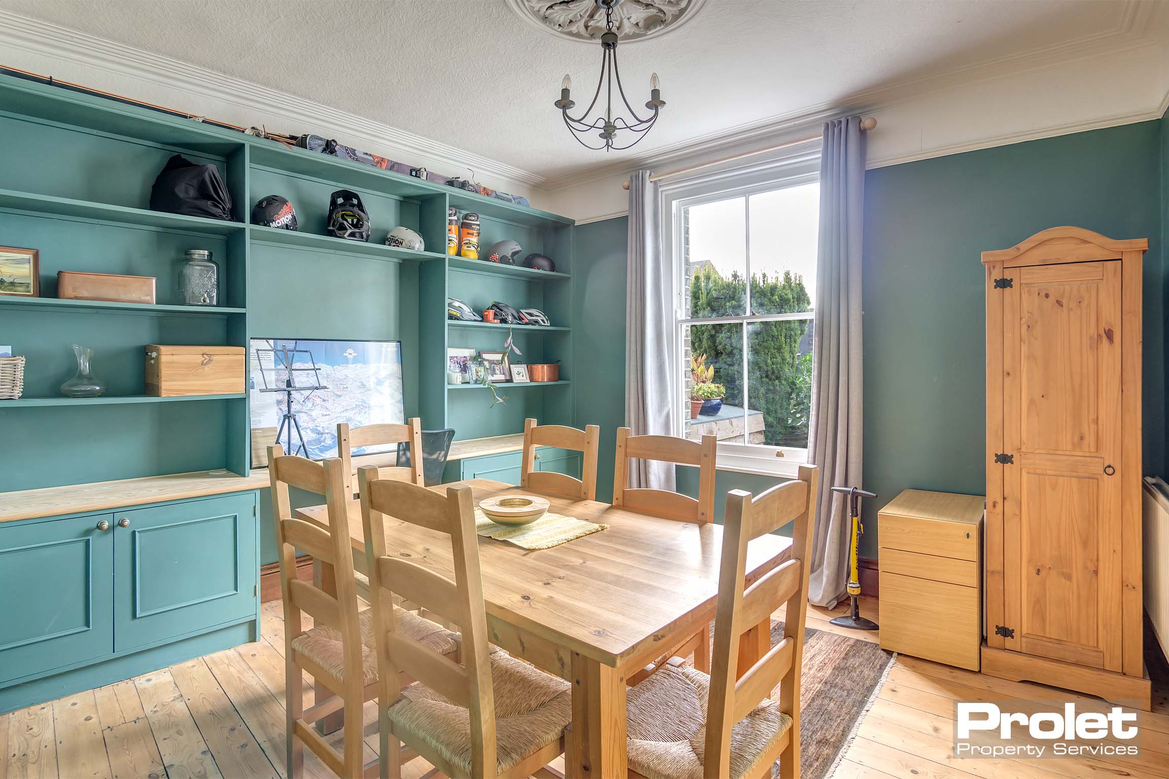 Dining room with built in shelves and cupboards, painted turquoise