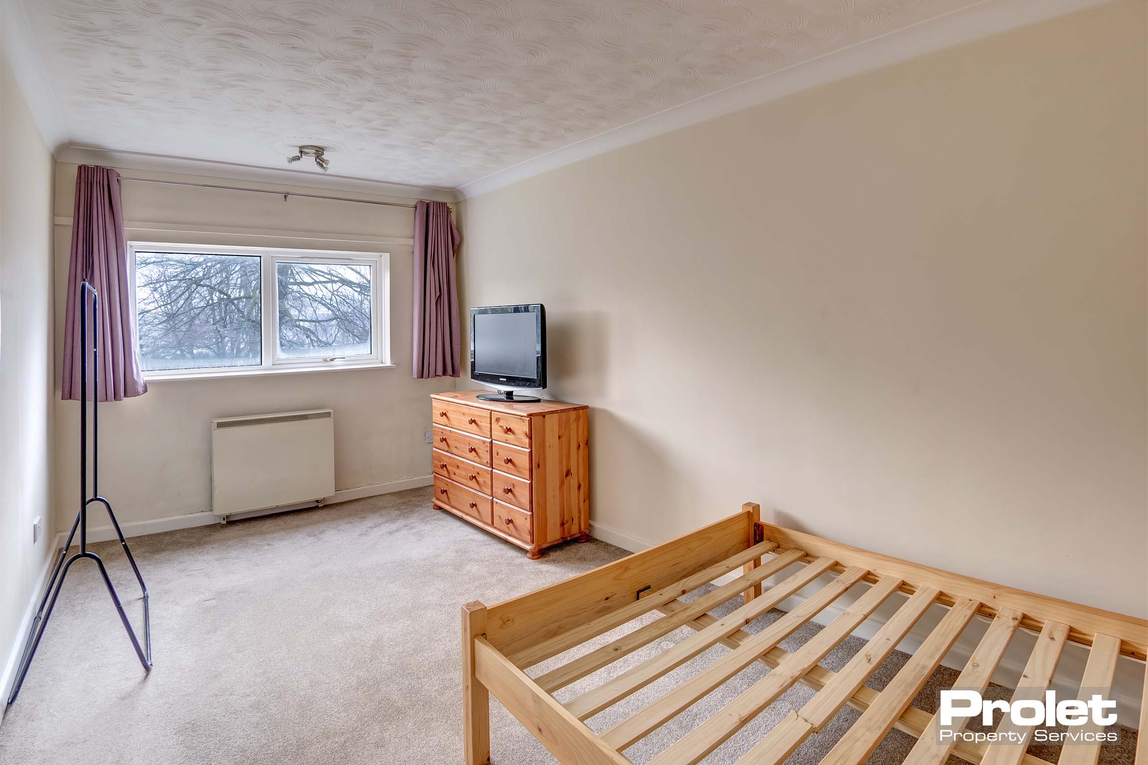 Cream carpets with magnolia walls. Large window over looking garden.