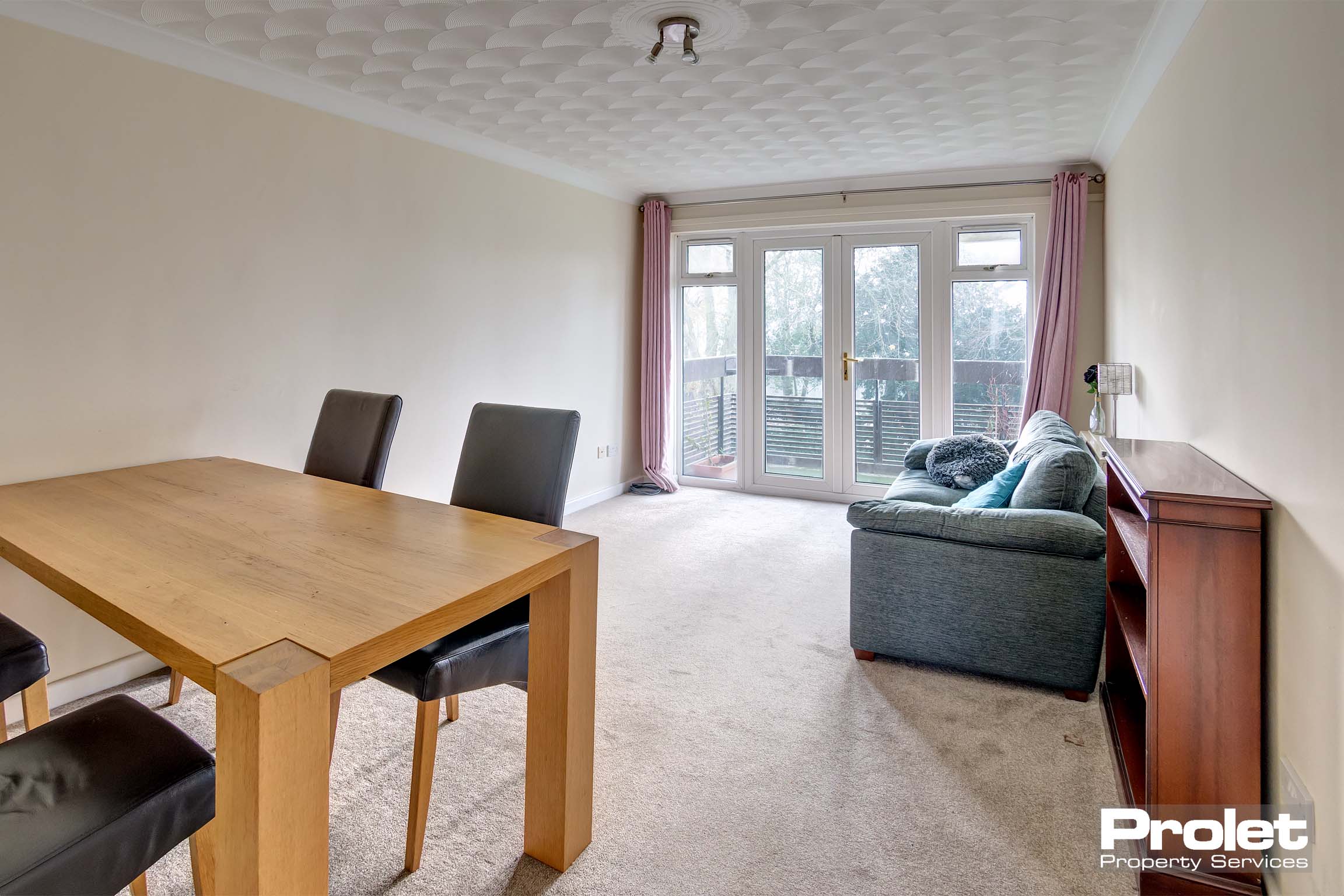Cream carpets with magnolia walls leading to balcony