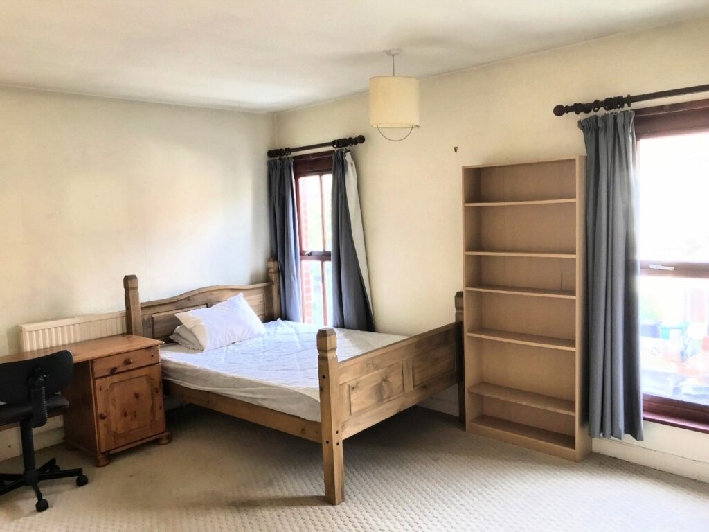 Bedroom with double bed and wooden furnishings