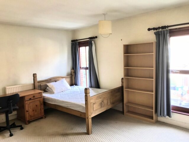 Bedroom with double bed and wooden furnishings
