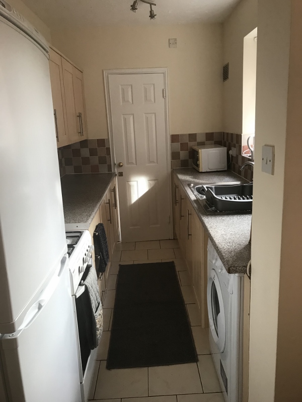 Galley style fitted kitchen with white goods