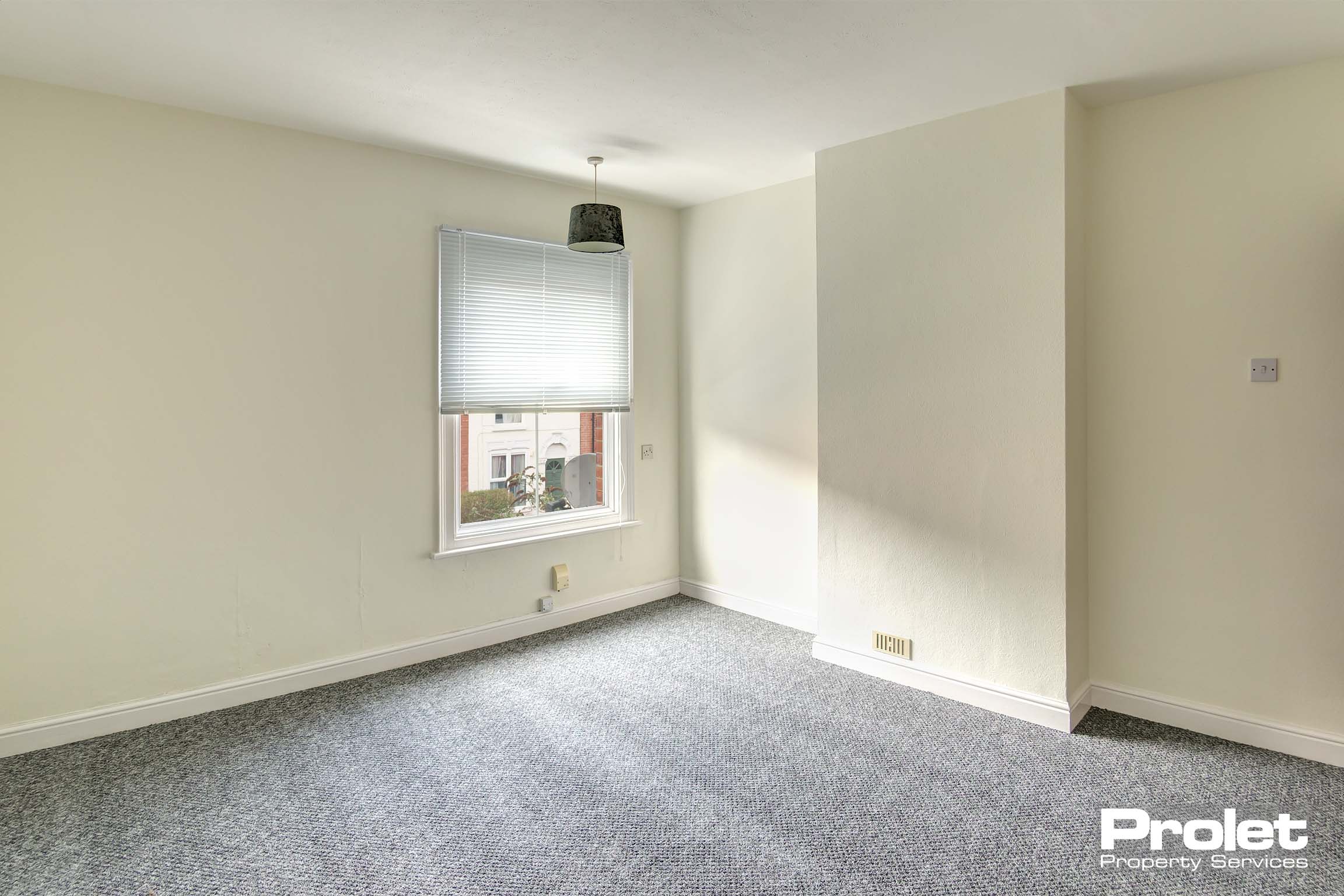 Double bedroom with cream walls and grey carpet