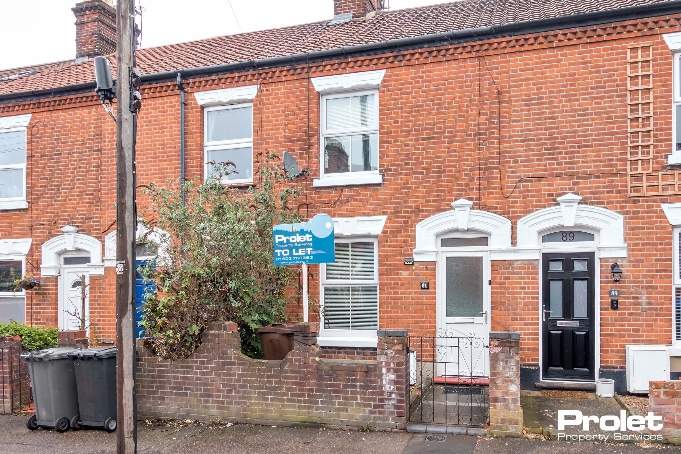 Red brick terraced house with UPVC doors and windows