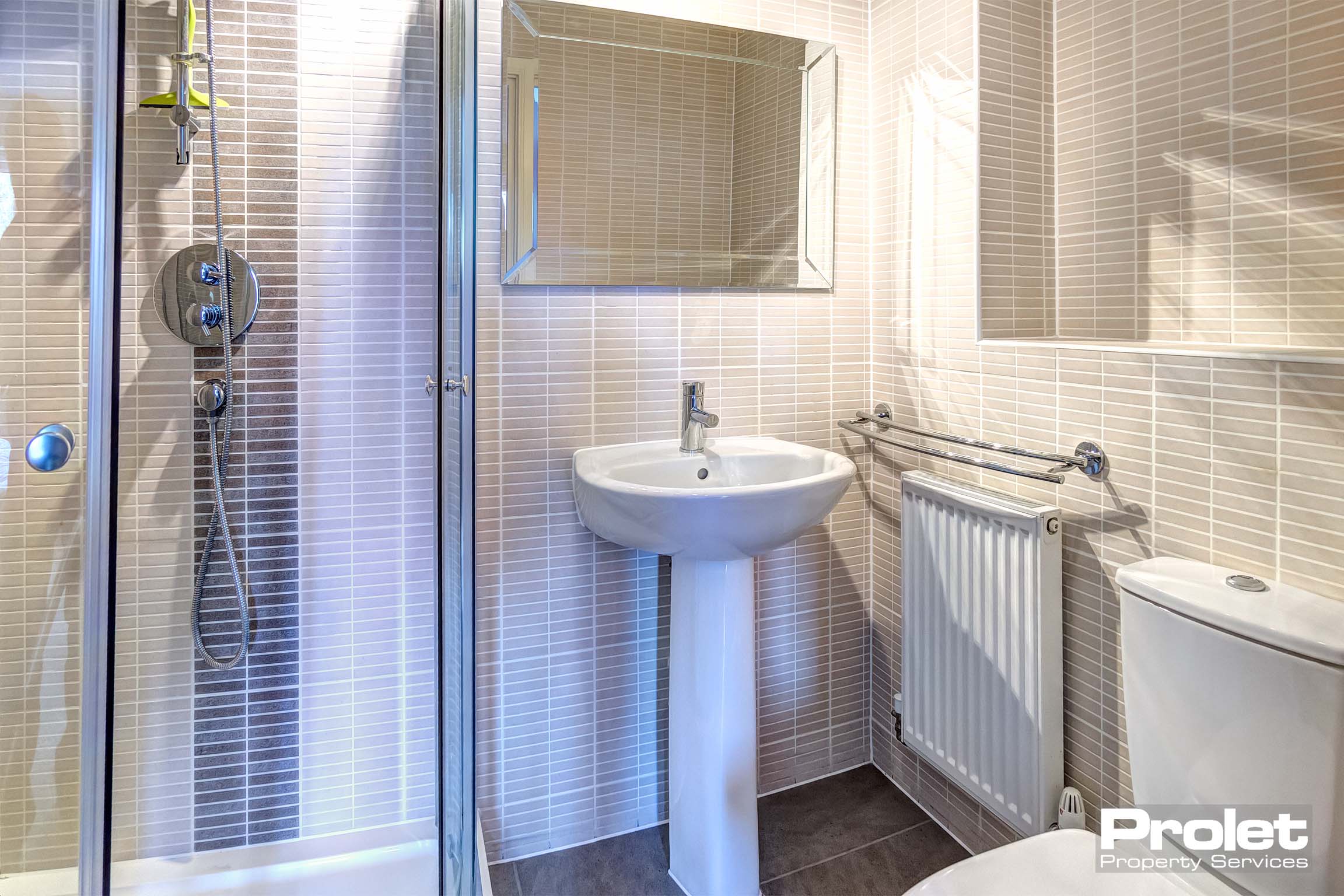 Bathroom with shower cubicle, toilet, and sink