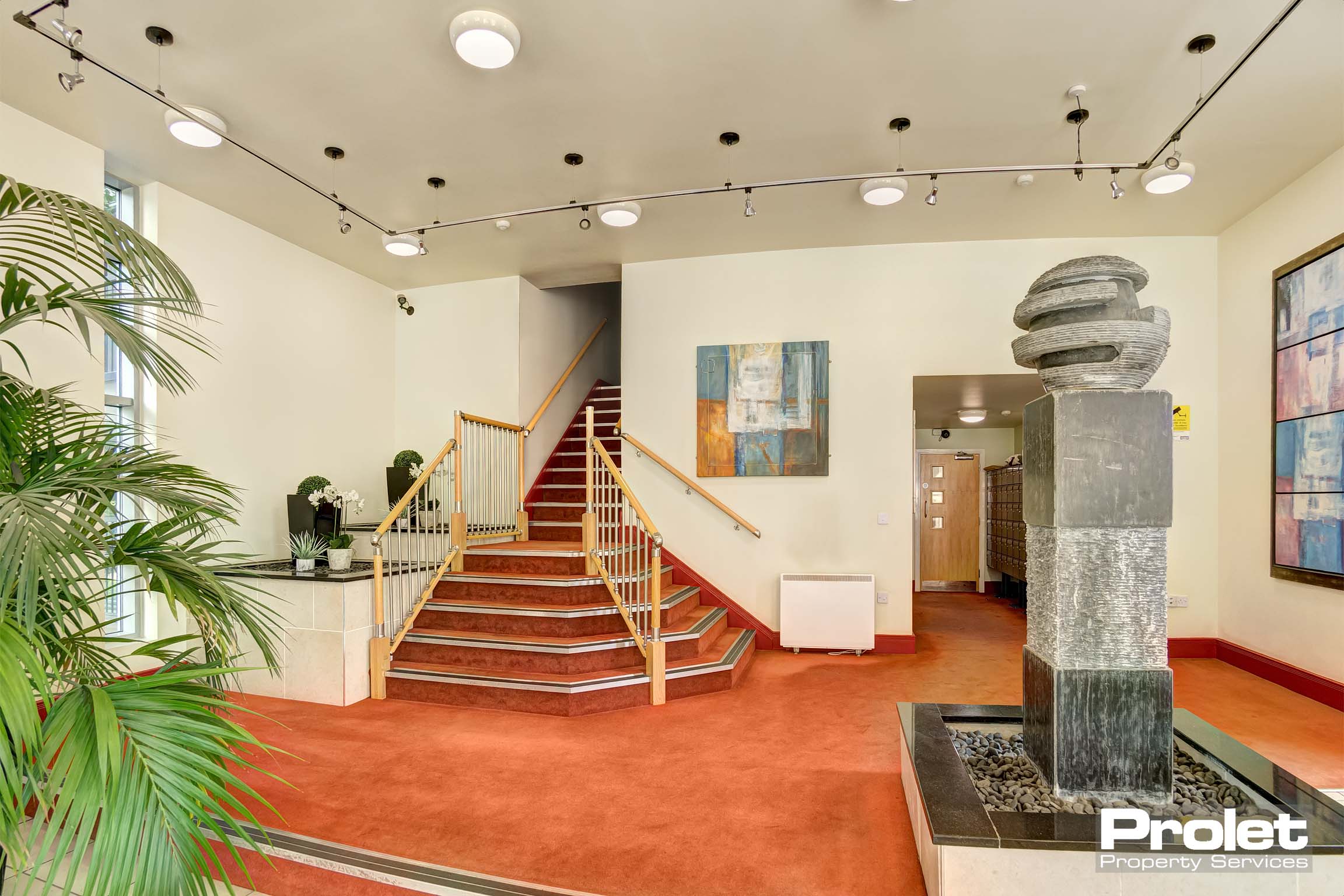 Lobby with red carpet and water feature, and