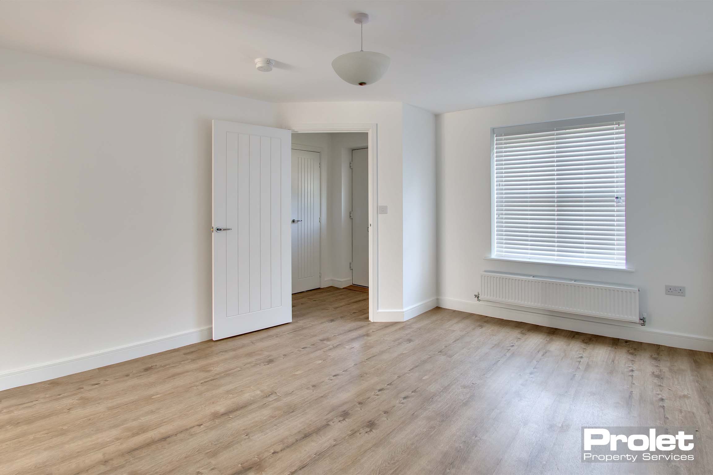off white walls with laminate flooring