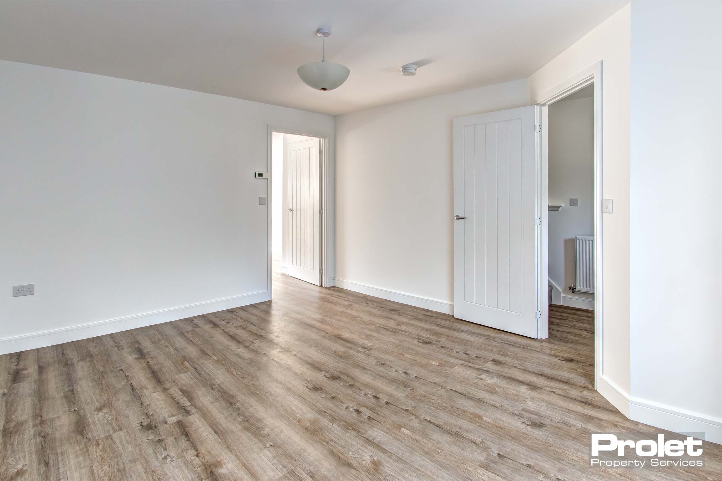 off white walls with laminate flooring