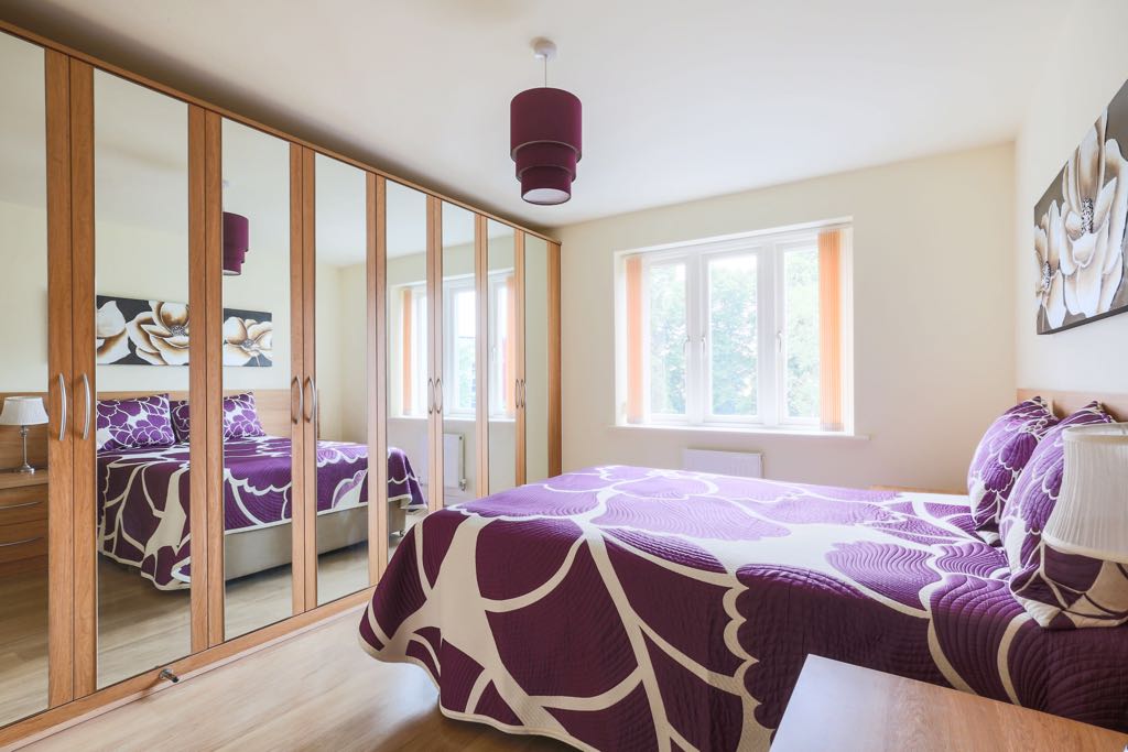 Double bedroom with built in storage with mirror fronts