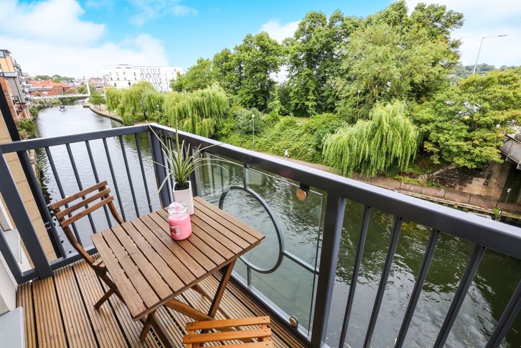 Balcony with decking and small bistro style outside table