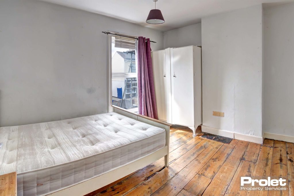 Double bedroom with wooden floors