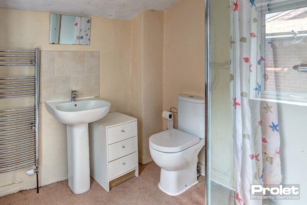 En-suite bathroom, toilet, sink, and shower cubicle.