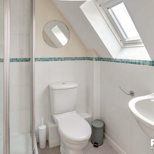 White tiled bathroom with walk in shower