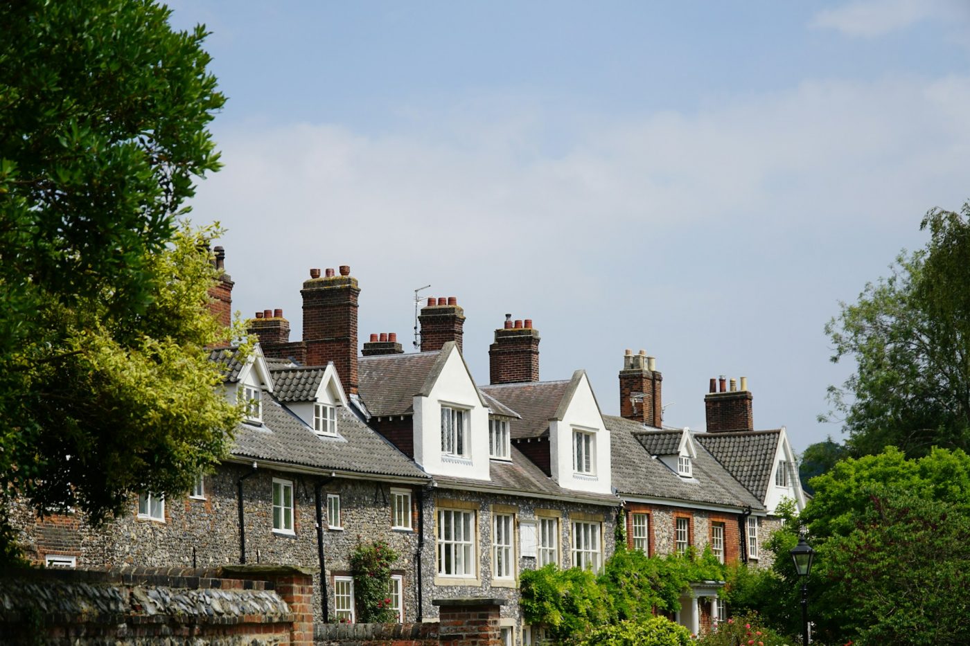 row of houses for rent with grey roofs and chimneys