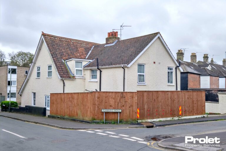 Corner property with white walls and fence